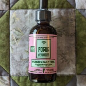 Glass bottle of Rogue Herbalist Women’s Daily Tonic Tincture 2oz with shatavari, dong quai, schisandra, raspberry leaf, damiana, and rose.